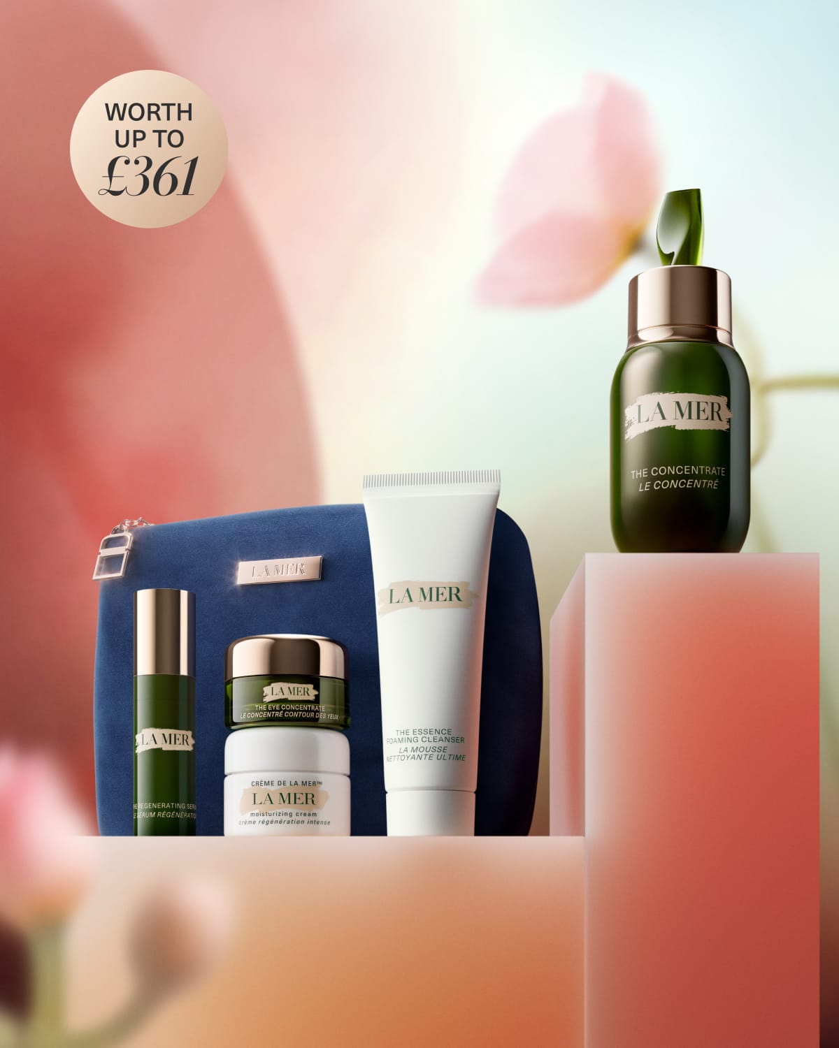 La Mer skincare gift set displayed on white blocks with a teal bag and products worth £242.