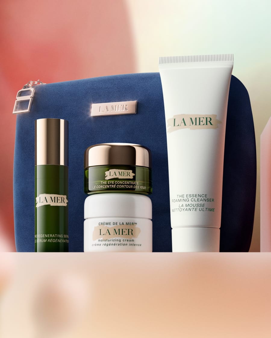La Mer skincare gift set displayed on white blocks with a teal bag and products worth £242.
