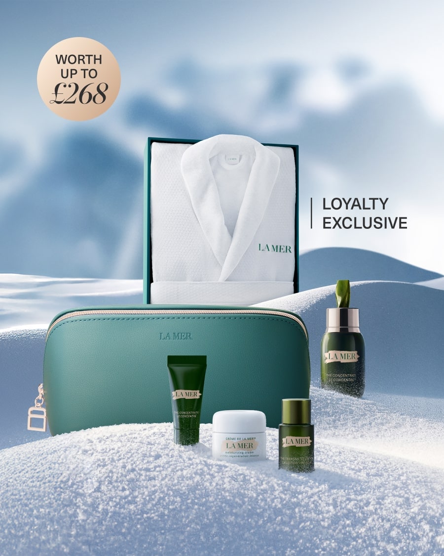 3 separate La Mer lip products nestled in snow, next to La Mer attendant caricature, with animated snow falling from the sky