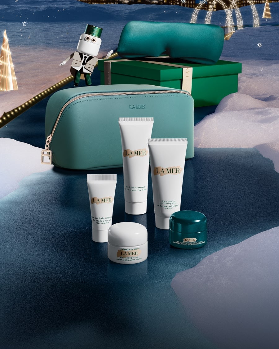 Selection of La Mer minis in a dynamic, twilight lit setting, with The Eye Concentrate mini on a glass shelf