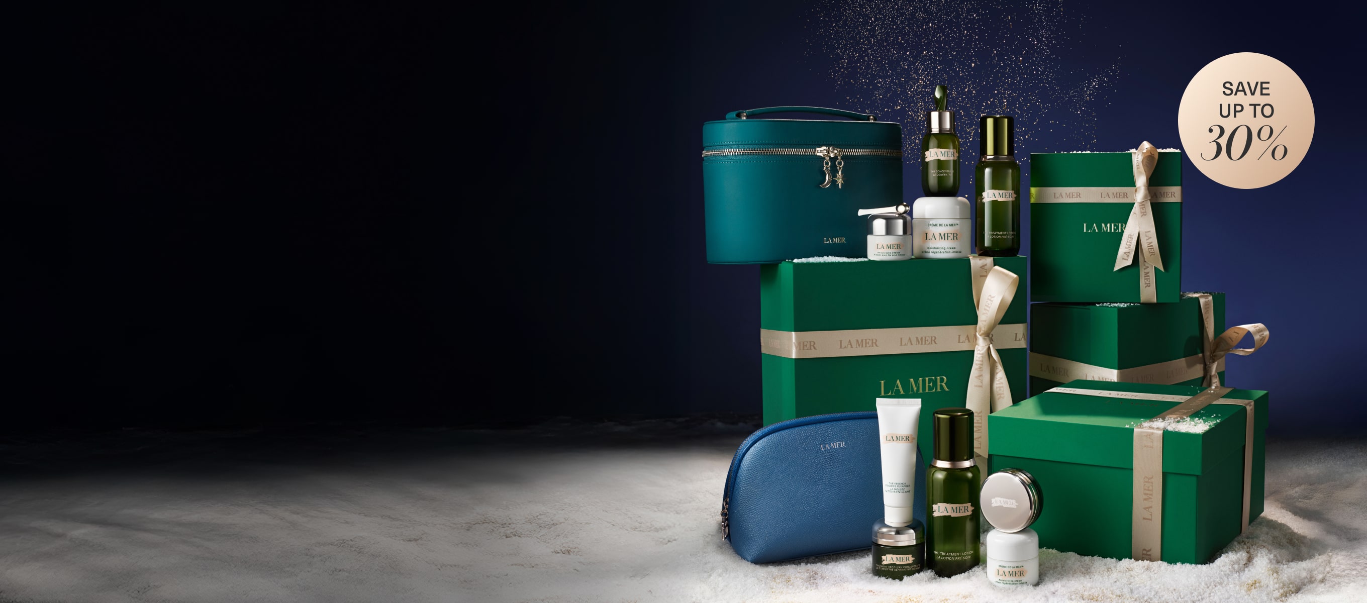 Our exclusive 2025 Black Friday sets, nested on top of our signature green La Mer gift boxes, in a snow-filled setting