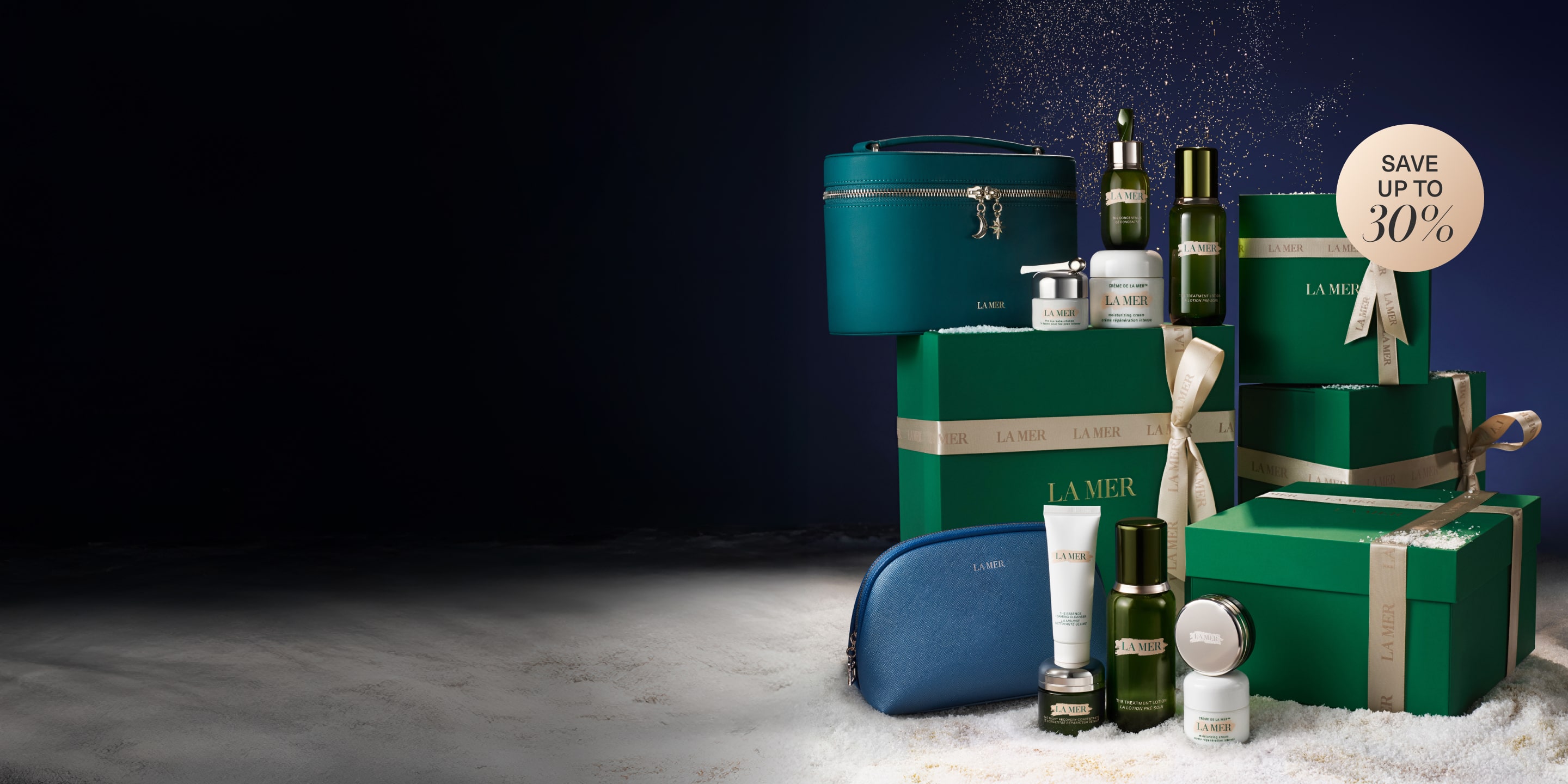 Our exclusive 2025 Black Friday sets, nested on top of our signature green La Mer gift boxes, in a snow-filled setting