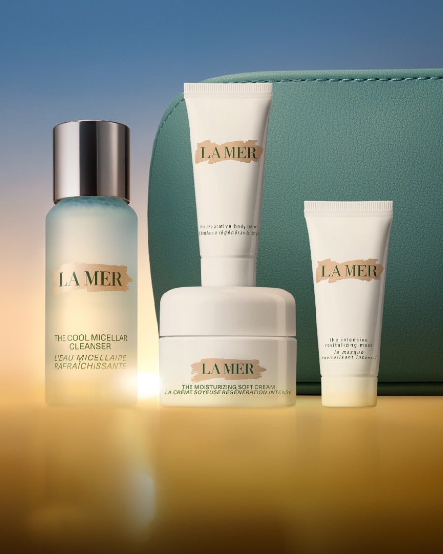 Selection of La Mer minis in a dynamic, twilight lit setting, with The Eye Concentrate mini on a glass shelf