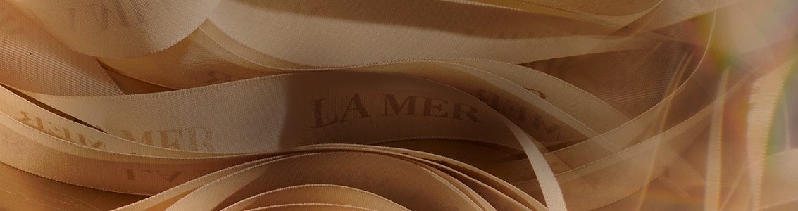 Cream ribbon with La Mer Logo on